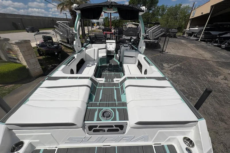 Slide: The Image of 2026 Supra SE 550 boat with sleek white seating and modern design. - 16