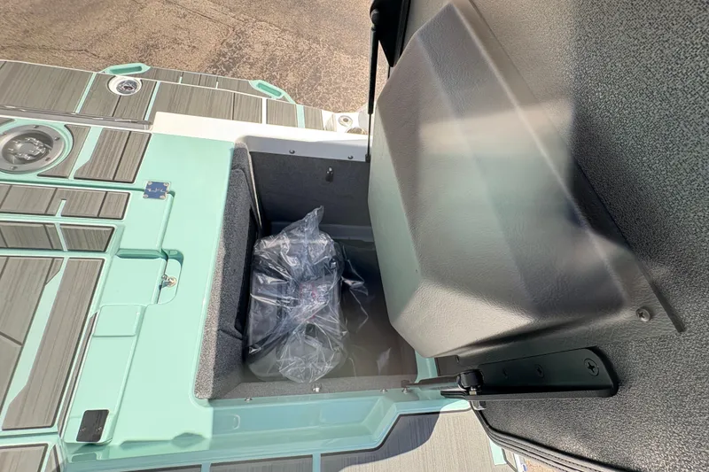 Slide: The Image of Storage compartment of 2026 Supra SE 550 boat with teal and gray accents. - 19
