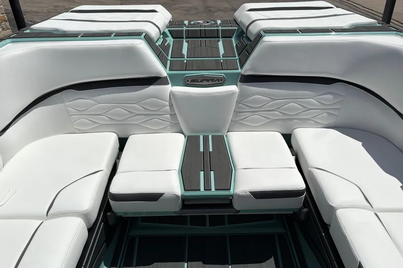 Slide: The Image of 2026 Supra SE 550 boat interior with white and teal seating, modern design. - 23