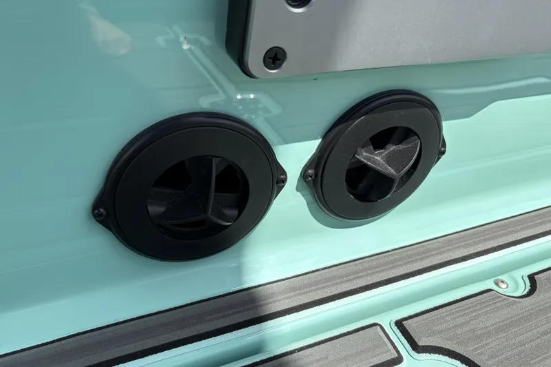 Slide: The Image of Close-up of 2026 Supra SE 550 boat exhaust vents on teal surface. - 28