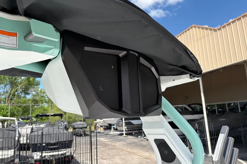 Slide: The Image of 2026 Supra SE 550 boat speaker system under canopy, outdoor setting. - 32