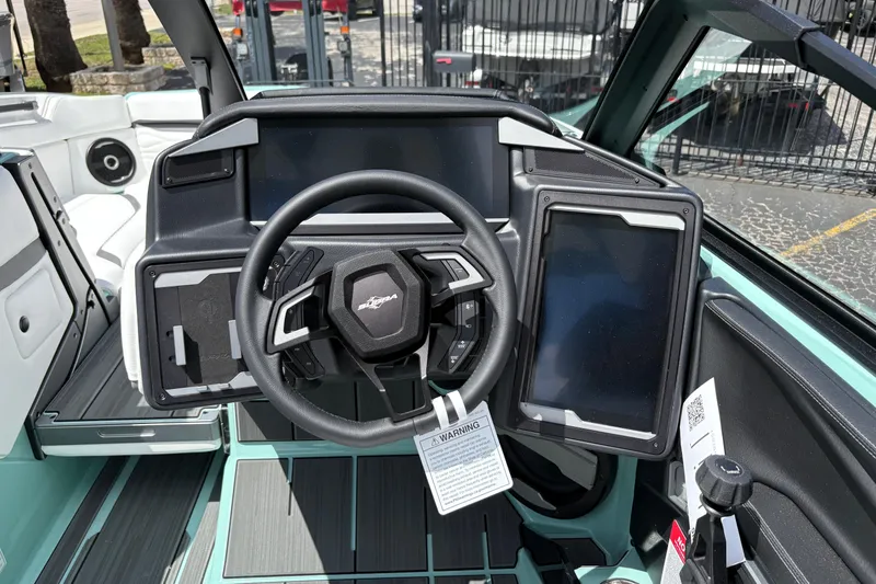 Slide: The Image of 2026 Supra SE 550 boat dashboard with steering wheel and digital display. - 37