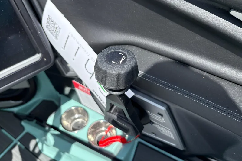 Slide: The Image of Interior of 2026 Supra SE 550 showing control knob and cup holders. - 38