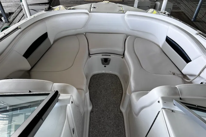 Slide: The Image of 2010 Chaparral Sunesta 224 boat interior with white seating and carpeted floor. - 11