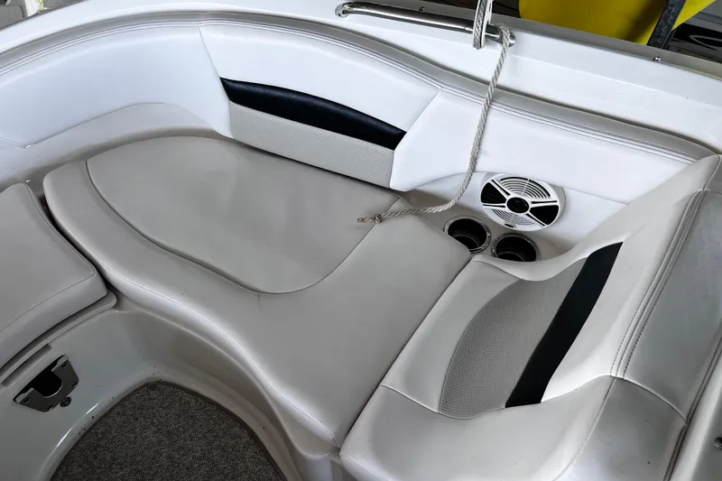 Slide: The Image of 2010 Chaparral Sunesta 224 boat interior with white seating and cup holders. - 12