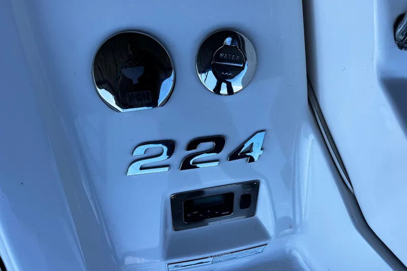 Slide: The Image of 2010 Chaparral Sunesta 224 boat dashboard with chrome details and controls. - 18