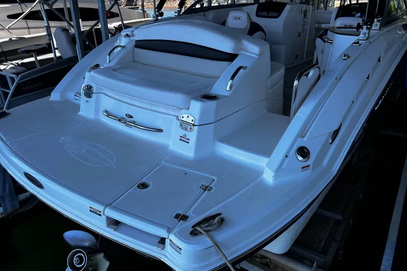 Slide: The Image of 2010 Chaparral Sunesta 224 boat, featuring a spacious white deck and seating area. - 4