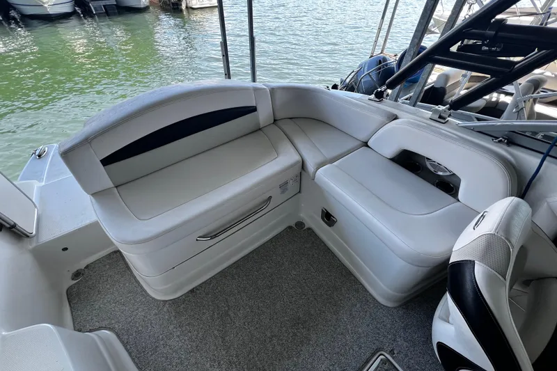 Slide: The Image of 2010 Chaparral Sunesta 224 boat interior with white seating and water view. - 7
