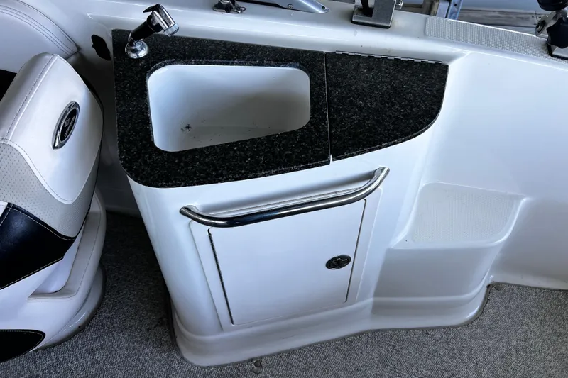 Slide: The Image of 2010 Chaparral Sunesta 224 boat interior with sink and storage compartment. - 8