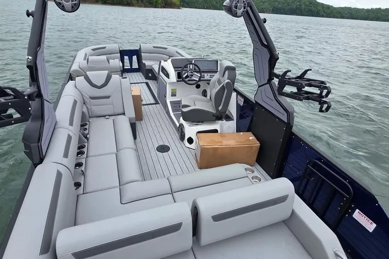 Slide: The Image of 2026 Montara Surf Boss EVO SLDH 25' boat with spacious seating and modern helm on a lake. - 1