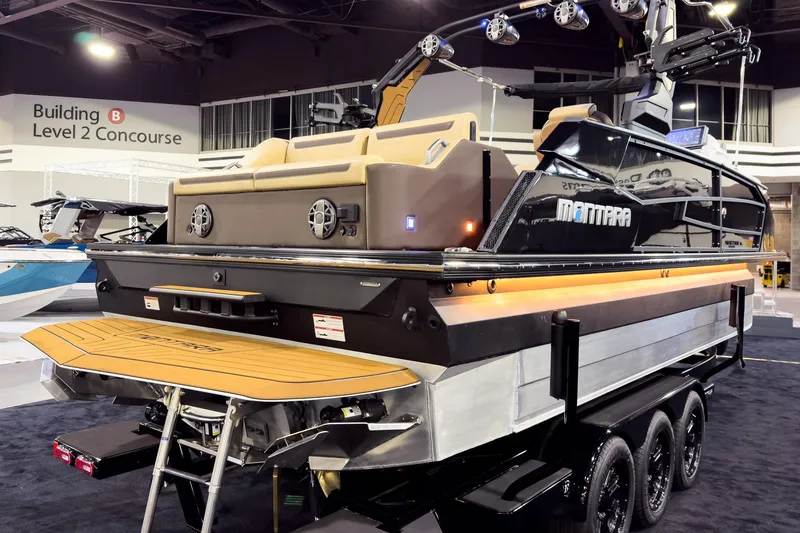 Slide: The Image of 2026 Montara Surf Boss EVO - SLDH 25' boat displayed indoors on a trailer. - 12