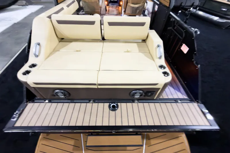 Slide: The Image of 2026 Montara Surf Boss EVO SLDH 25' boat interior with beige seating and cup holders. - 27