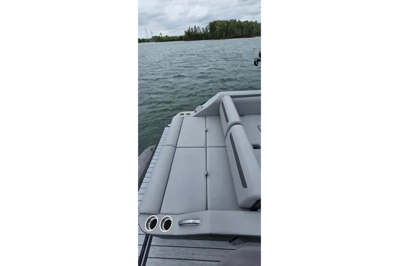 Slide: The Image of 2026 Montara Surf Boss EVO boat on a lake, featuring sleek gray seating. - 4