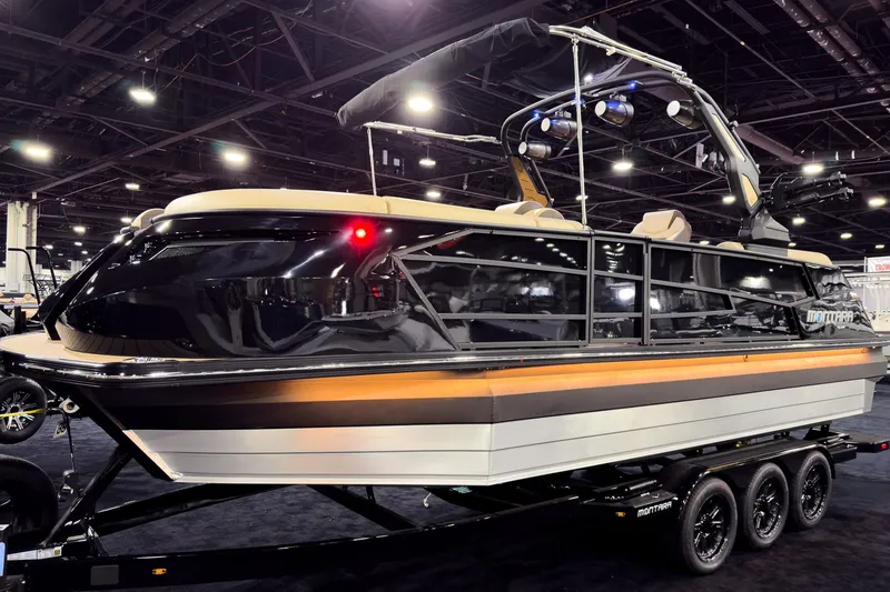 Slide: The Image of 2026 Montara Surf Boss EVO SLDH 25' boat displayed indoors on a trailer. - 7
