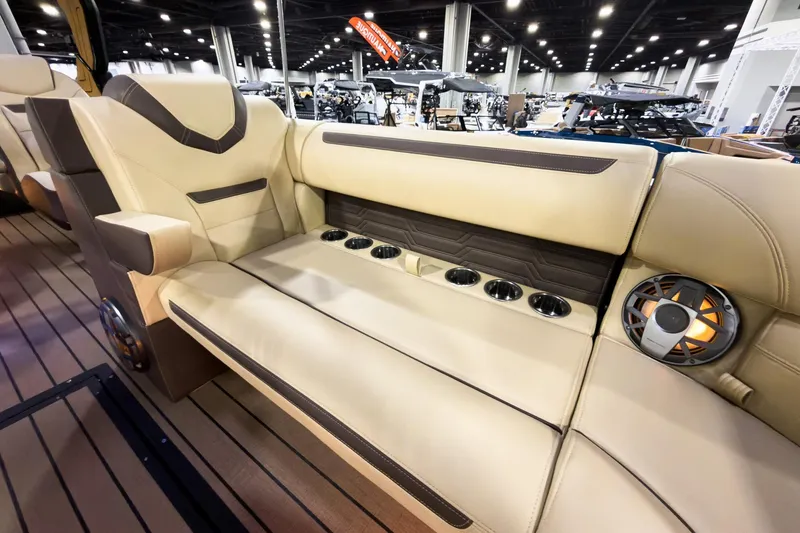 Slide: The Image of Luxurious seating in 2026 Montara Surf Boss EVO boat, featuring cup holders and speaker system. - 11