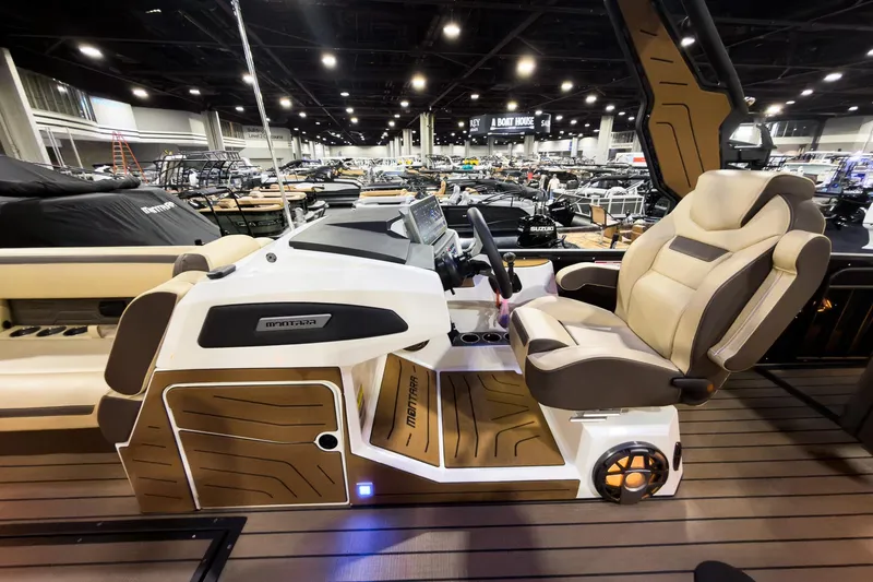 Slide: The Image of 2026 Montara Surf Boss EVO SLDH 25' boat interior with luxurious captain's chair and control panel. - 14