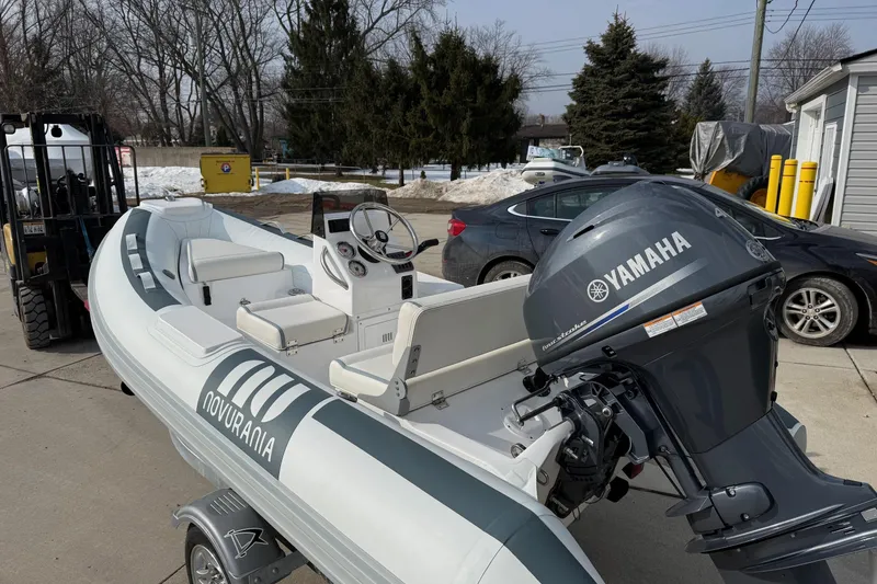 Slide: The Image of 2026 Novurania DL 360 boat with Yamaha engine on a trailer, parked outdoors. - 4