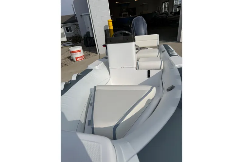 Slide: The Image of 2026 Novurania DL 360 boat interior with white seating and steering console. - 5