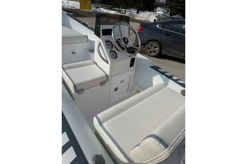 Slide: The Image of 2026 Novurania DL 360 boat interior with steering wheel and seating. - 6