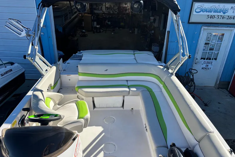Slide: The Image of 2018 Starcraft Star Step 221 I/O boat interior with green and white seating. - 3