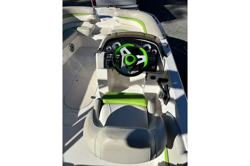 Slide: The Image of 2018 Starcraft Star Step 221 I/O boat interior with green accents and steering wheel. - 5