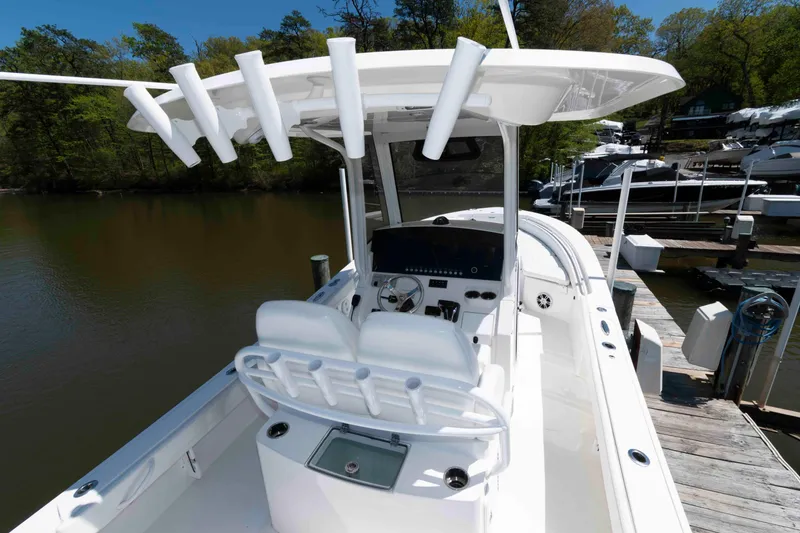 Slide: The Image of 2021 Regulator 26XO boat docked, featuring a sleek console and rod holders. - 21