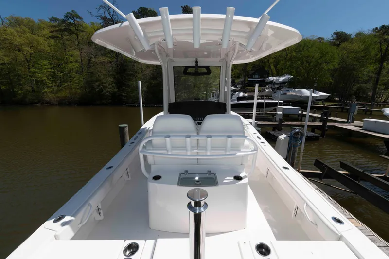 Slide: The Image of 2021 Regulator 26XO boat docked, featuring spacious deck and sleek design. - 23