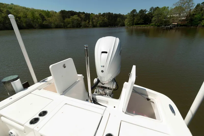 Slide: The Image of 2021 Regulator 26XO boat with V8 engine on a serene lake. - 24