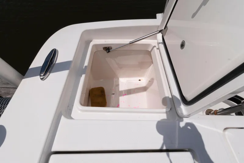 Slide: The Image of Open storage compartment on 2021 Regulator 26XO boat, featuring a clean interior. - 27