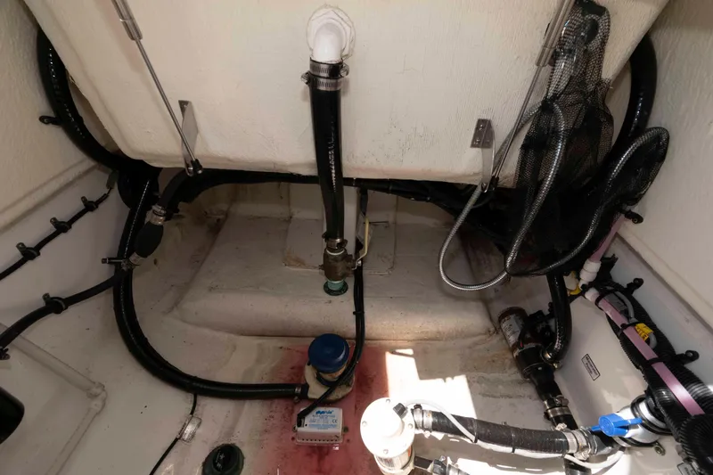 Slide: The Image of 2021 Regulator 26XO boat interior showing plumbing and wiring components. - 28