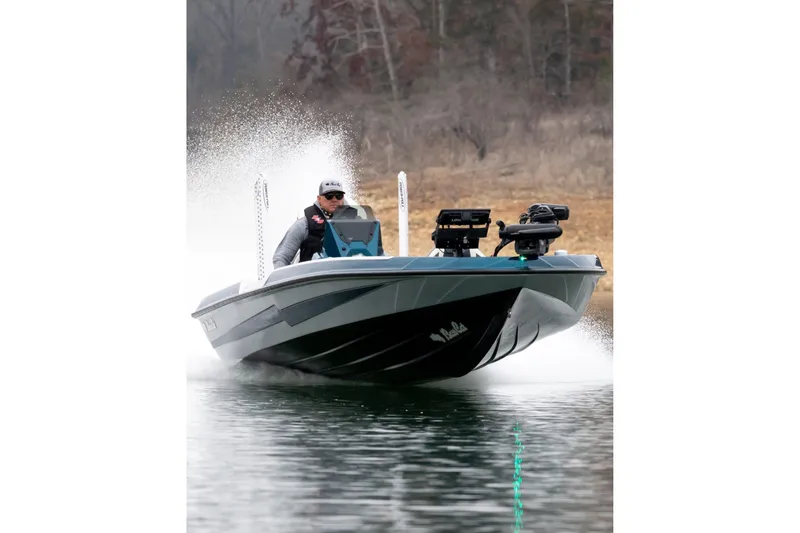 Slide: The Image of 2027 Bass Cat Pantera boat speeding on water, creating a splash, with a driver in sunglasses. - 4