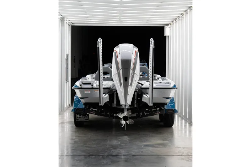 Slide: The Image of 2027 Bass Cat Pantera boat in a modern storage facility, rear view. - 5