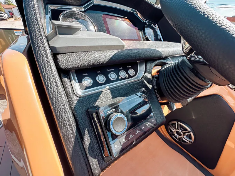 Slide: The Image of 2025 Godfrey AquaPatio 23' Flip Lounge Tritoon dashboard with controls and stereo system. - 11