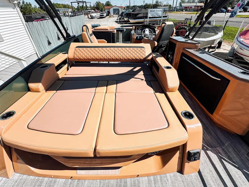 Slide: The Image of 2025 Godfrey AquaPatio 23' Flip Lounge Tritoon with luxurious tan seating and modern design. - 18