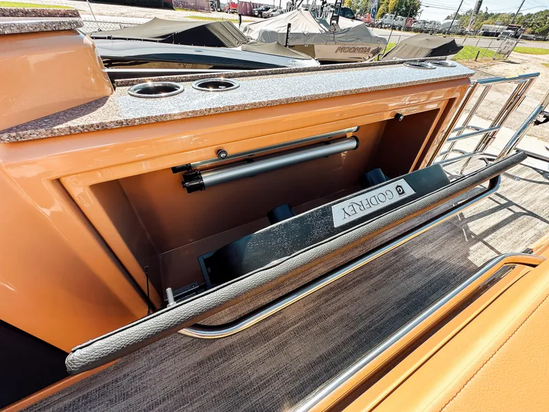 Slide: The Image of 2025 Godfrey AquaPatio 23' Flip Lounge Tritoon with sleek bar area and cup holders. - 22