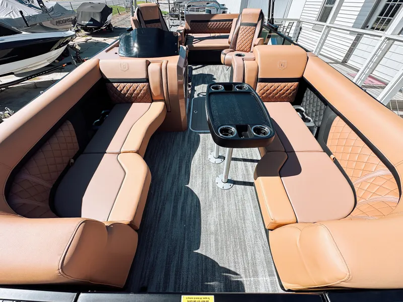 Slide: The Image of Luxurious 2025 Godfrey AquaPatio 23' Tritoon with elegant tan seating and modern design. - 5