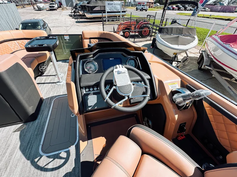 Slide: The Image of 2025 Godfrey AquaPatio 23' Flip Lounge Tritoon interior with modern dashboard and seating. - 12