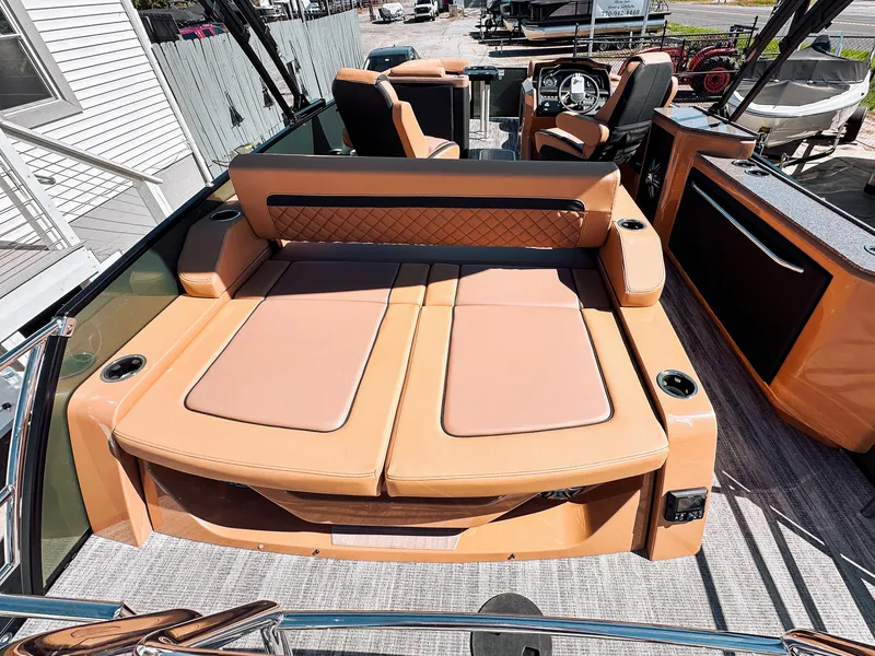 Slide: The Image of 2025 Godfrey AquaPatio 23' Flip Lounge Tritoon with luxurious tan seating and modern design. - 15