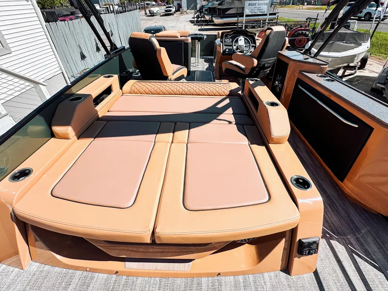 Slide: The Image of 2025 Godfrey AquaPatio 23' Flip Lounge Tritoon with luxurious tan seating and modern design. - 16