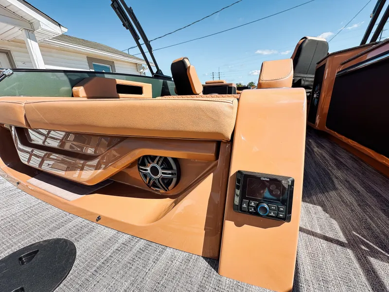 Slide: The Image of 2025 Godfrey AquaPatio 23' Flip Lounge Tritoon interior with tan seating and audio system. - 20