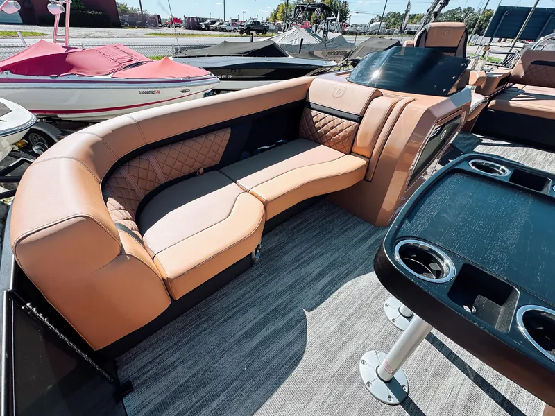 Slide: The Image of 2025 Godfrey AquaPatio 23' Tritoon with luxurious tan seating and modern design. - 6