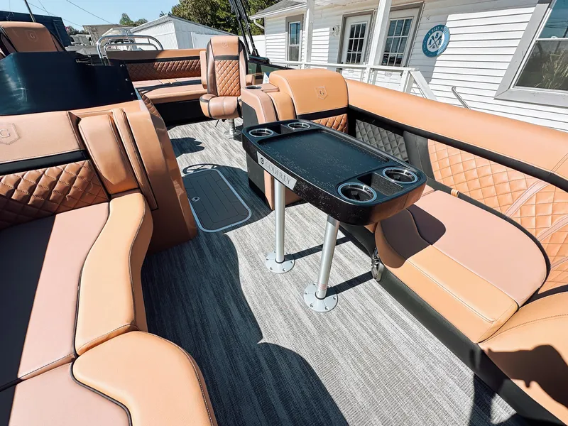 Slide: The Image of Luxurious interior of 2025 Godfrey AquaPatio 23' Flip Lounge Tritoon with tan seating and table. - 7