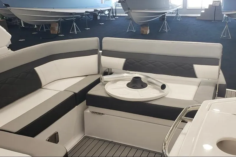 Slide: The Image of 2022 Monterey 295 Sport Yacht interior with sleek seating and modern amenities by the water. - 12