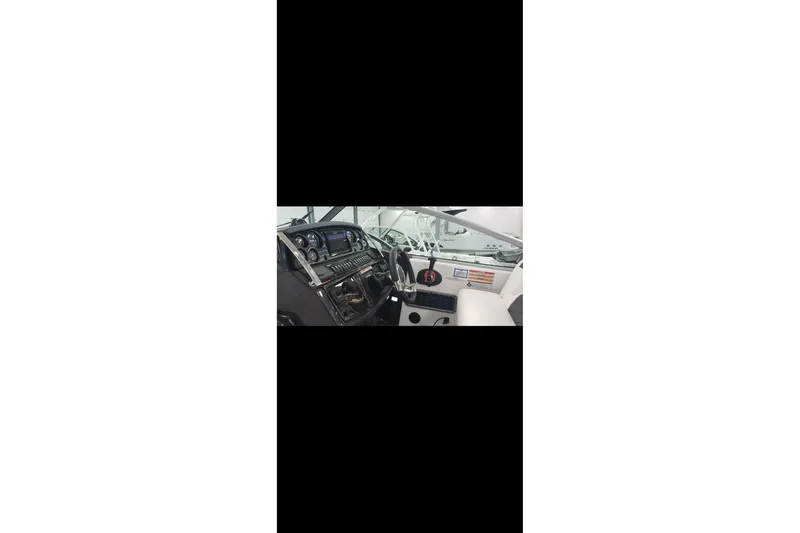 Slide: The Image of 2022 Monterey 295 Sport Yacht interior with sleek sink, seating, and modern design. - 13