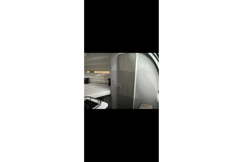 Slide: The Image of Interior view of 2022 Monterey 295 Sport Yacht cockpit with sleek design and modern controls. - 15