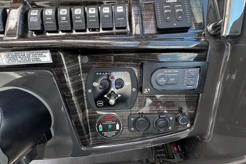 Slide: The Image of Control panel of a 2022 Monterey 295 Sport Yacht with various switches and dials. - 19
