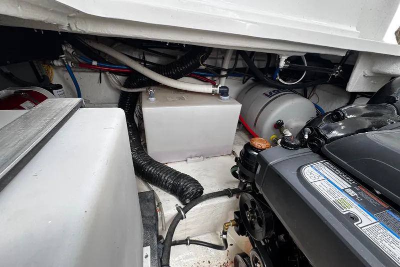 Slide: The Image of Engine compartment of a 2022 Monterey 295 Sport Yacht, showcasing mechanical components and wiring. - 21