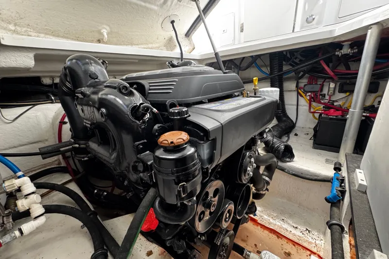 Slide: The Image of Engine compartment of a 2022 Monterey 295 Sport Yacht, showcasing detailed mechanical components. - 23
