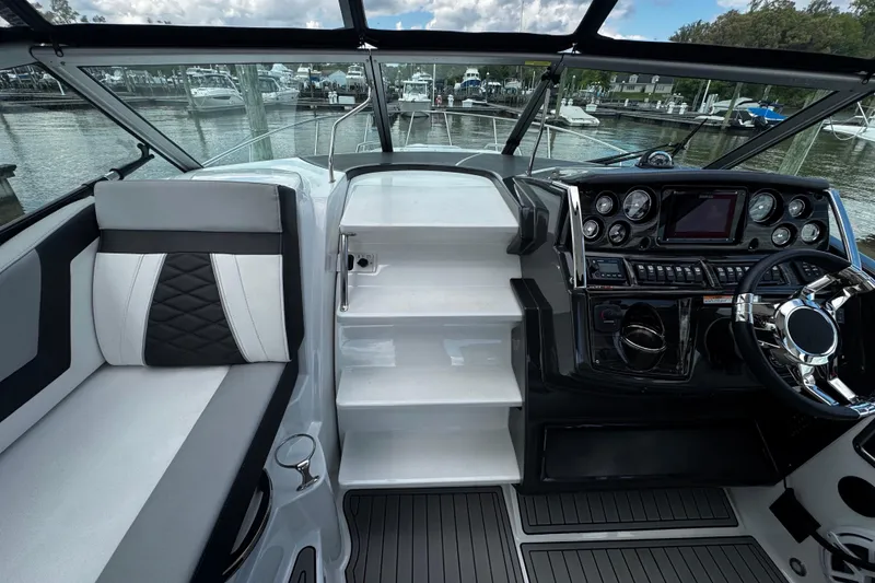 Slide: The Image of Interior view of 2022 Monterey 295 Sport Yacht cockpit with modern controls and seating. - 24
