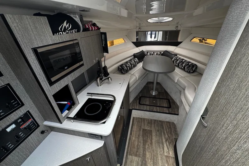 Slide: The Image of Interior of 2022 Monterey 295 Sport Yacht with modern kitchen and cozy seating area. - 25